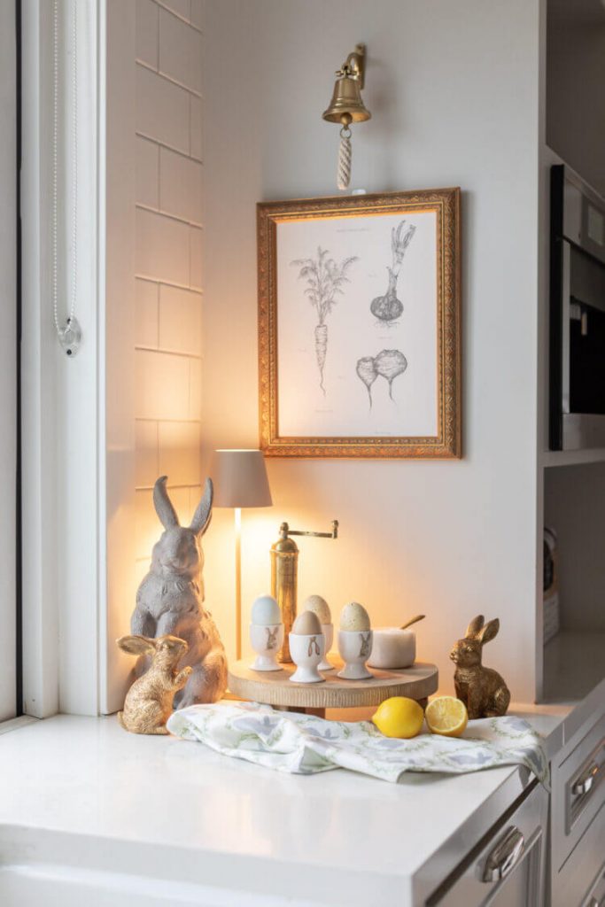 Spring themed Kitchen Corner Decor display with dyed eggs in egg cups and wooden rabbits