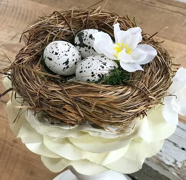 spring themed nest decor with speckled hand dyed eggs.