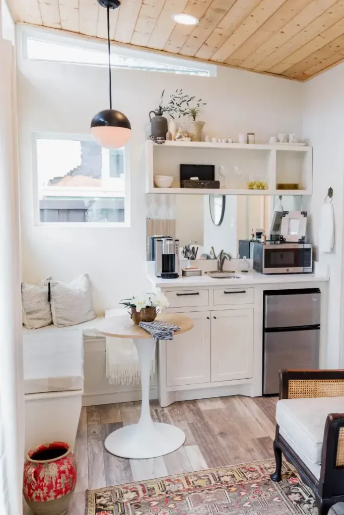 Small breakfast nook and with tiny round table and l shaped bench.