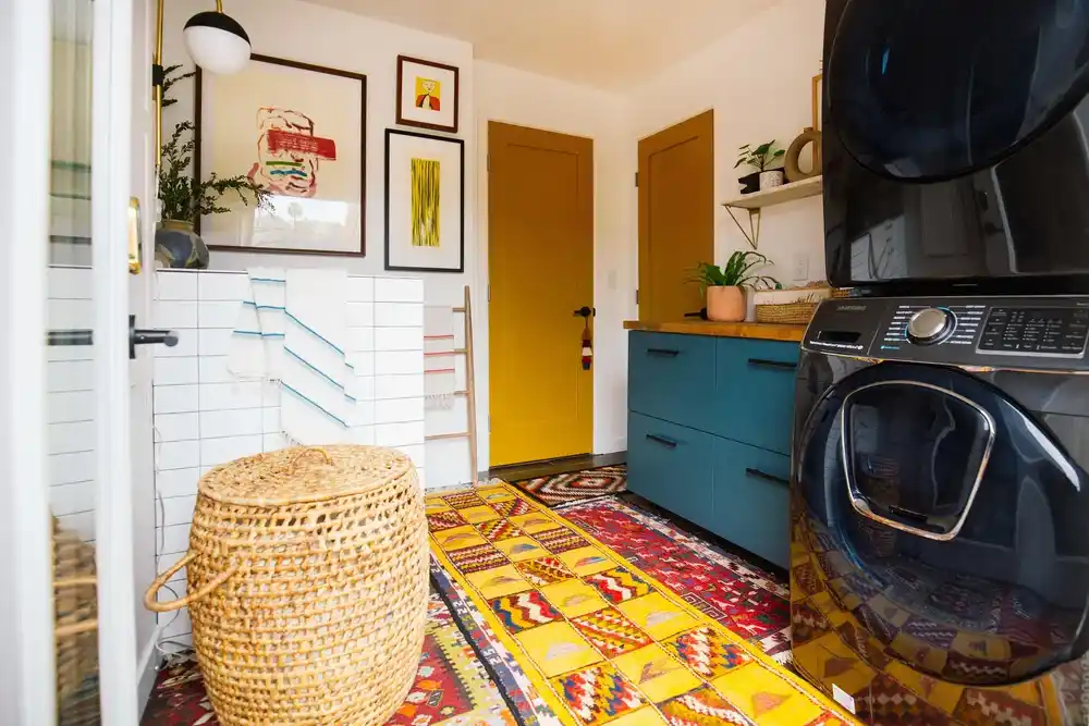 laundry room with colorful rugs found in a thrift store.