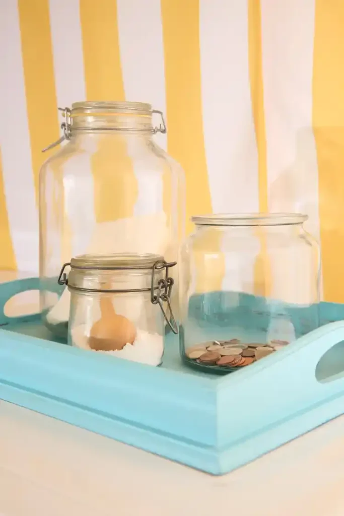 vintage bottles and jars as laundry room decor and organization.