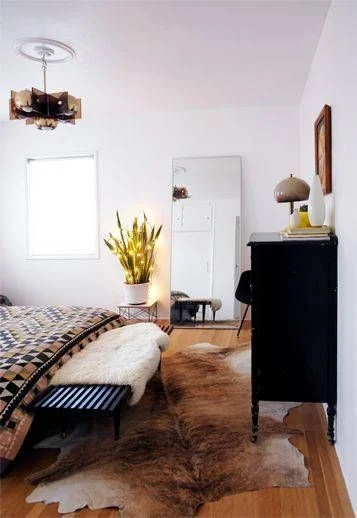Western inspired bedroom with cowhide rug.