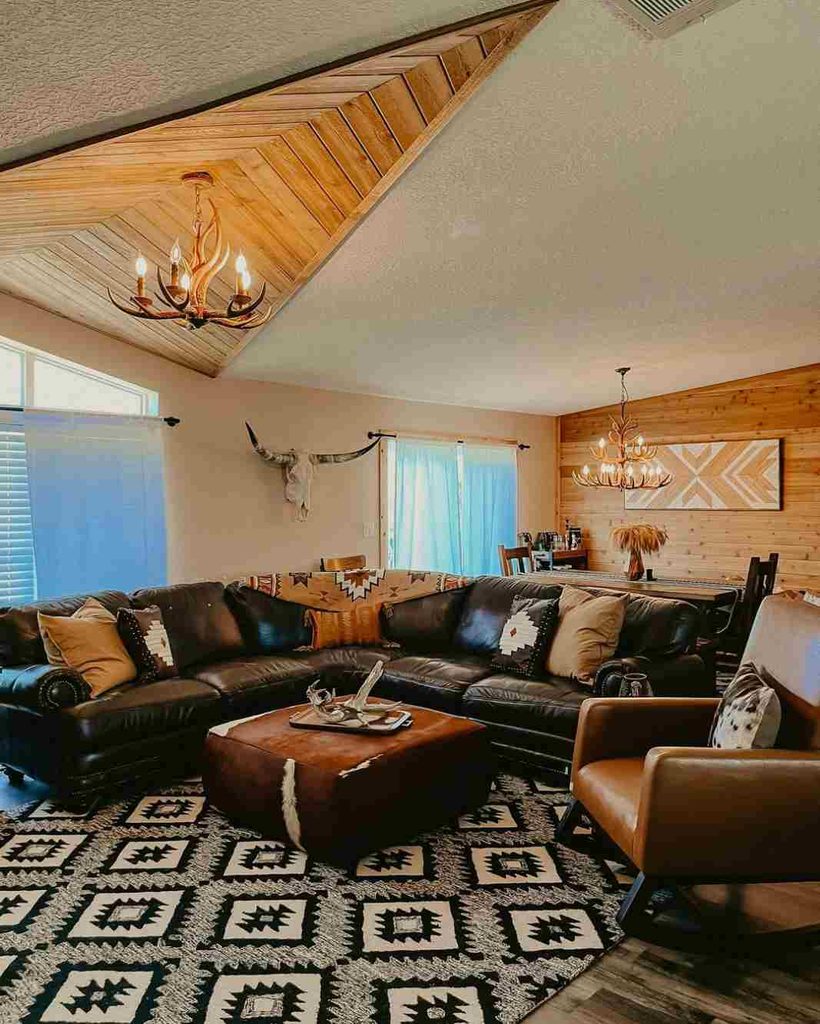 Antler chandeliers give a warm glow to western styled living and dining room.