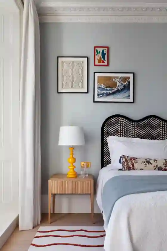 Homey apartment bedroom with tufted headboard, quilted bedding, thick rug, and layered textures creating a cozy style of home decor.
