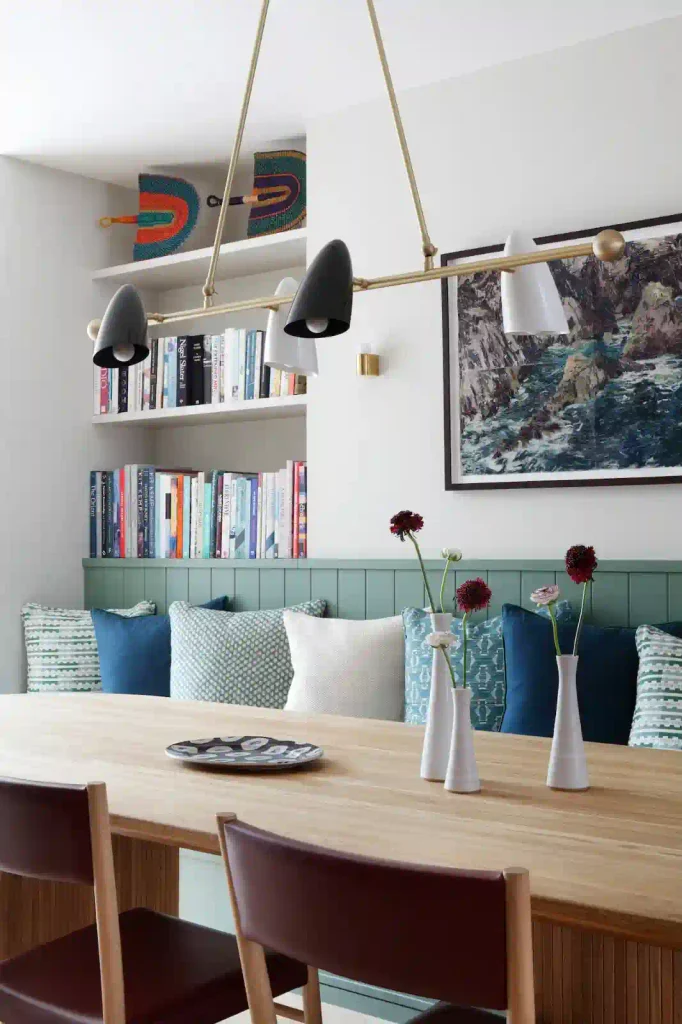 Apartment dining area with a cushioned bench showing interior design for small spaces and cozy apartment ideas.
