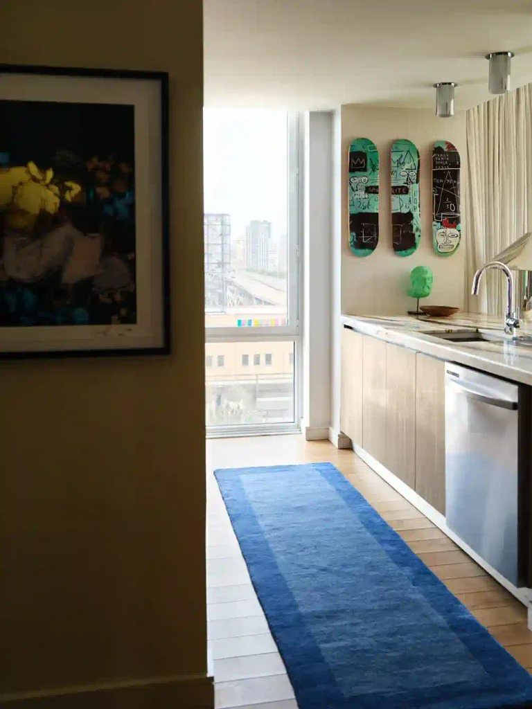 Kitchen featuring skateboards as wall art in a homey apartment reflecting a personal style of home decor and sustainable home decor. 
