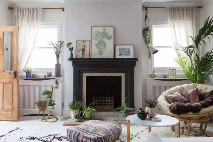 Homey apartment decorating with a papasan chair, layered rugs, boho floor pouf, and plants for home decor.
