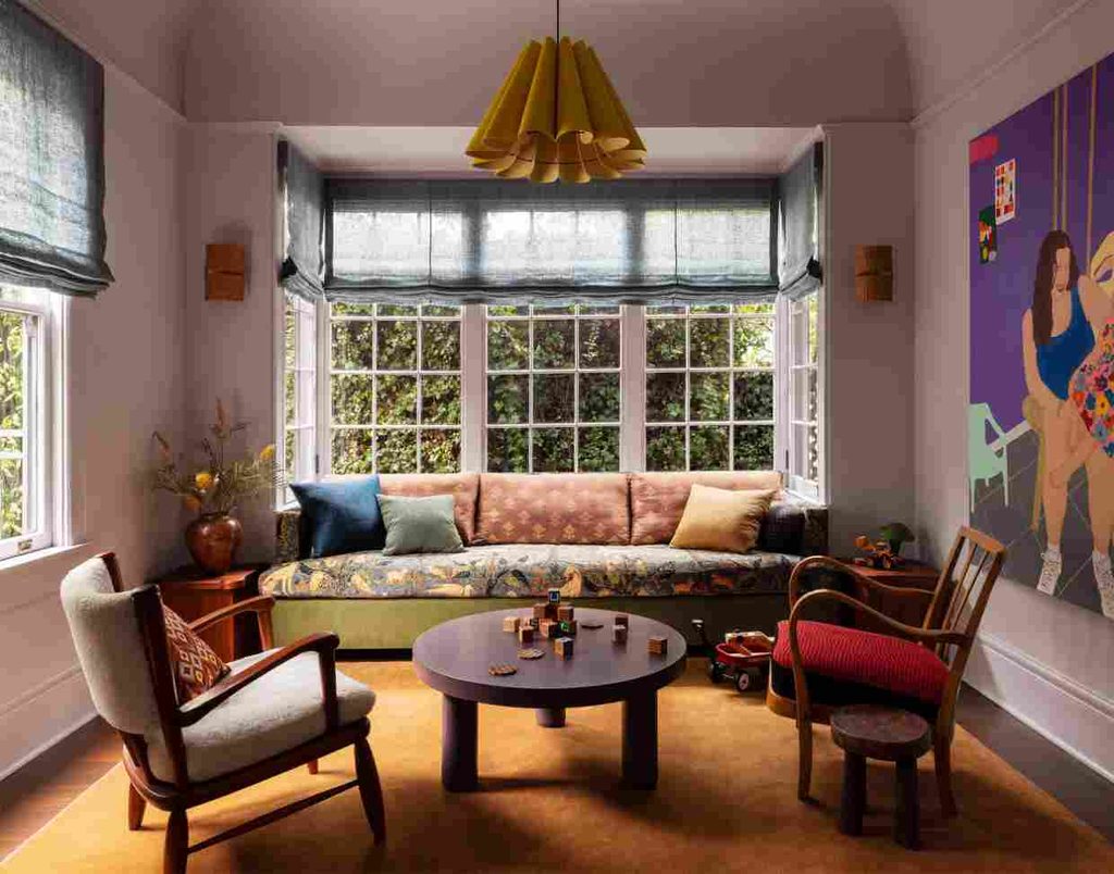 Cozy apartment living room with bold colors, vintage furniture, and warm tones showing a welcoming style of home decor.
