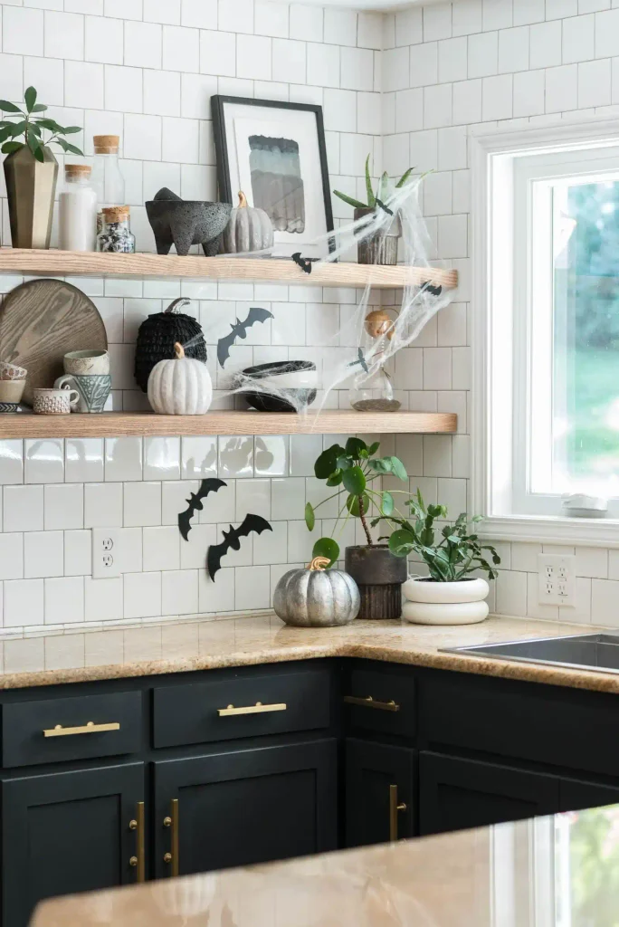 Open shelves decorated with miniature pumpkins , bats and Halloween decor.