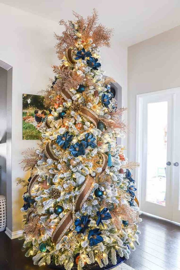 Dark blue poinsettia flowers decorating a bright Christmas tree
