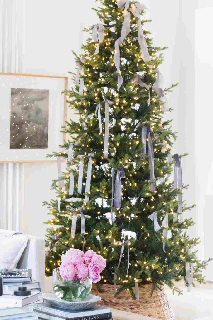 Blue gray Christmas ribbon woven through a green Christmas tree