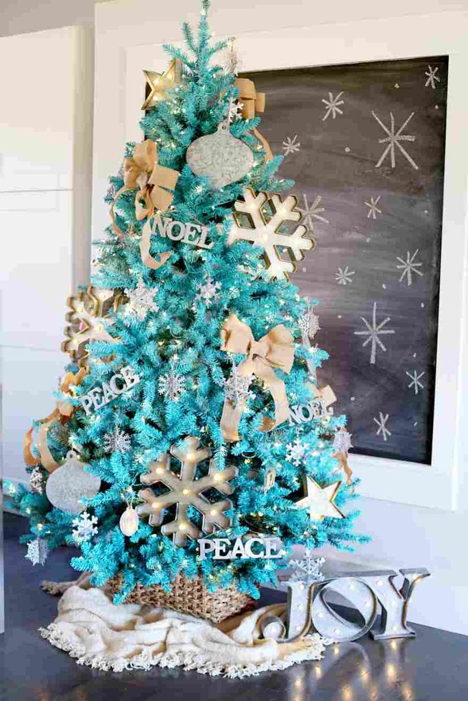 Bright blue Christmas tree decorated with bold silver ornaments