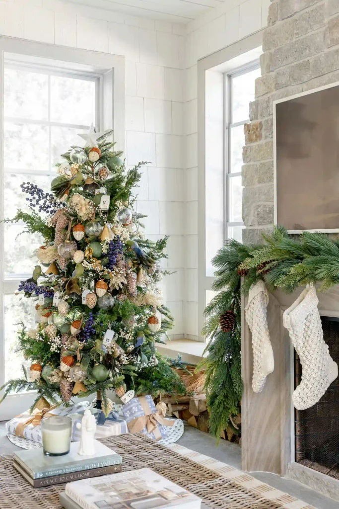 Maximalist Christmas tree decorated with blue berries and ornaments