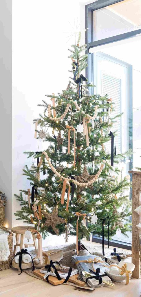 Navy blue Christmas ribbon decorating a sparse Christmas tree