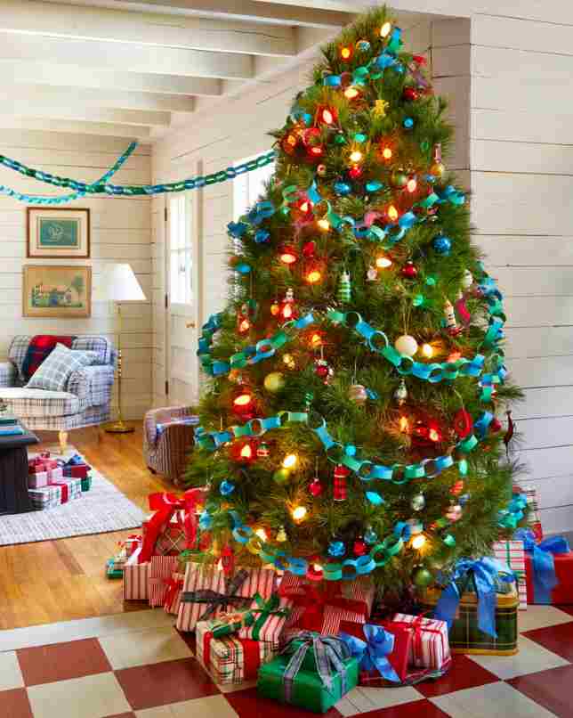 Handmade blue paper garland decorating a green Christmas tree