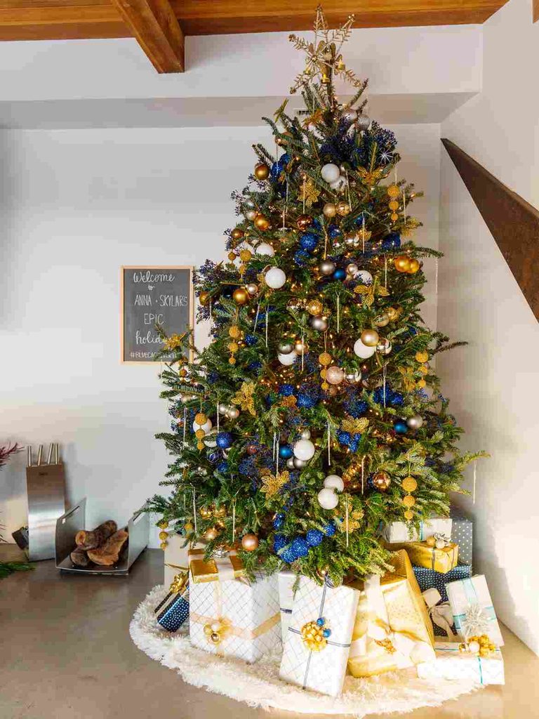 Traditional Christmas tree with bold blue ornaments and decorations