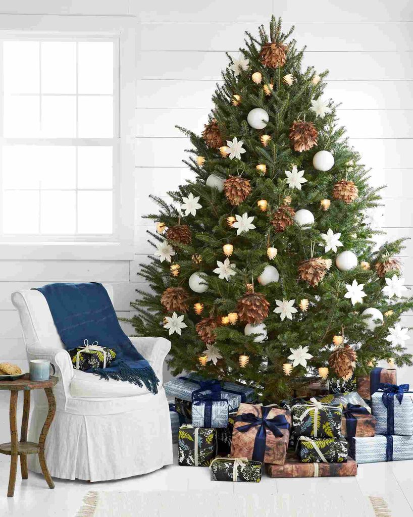 Rustic Christmas tree with blue ribbon used on presents underneath