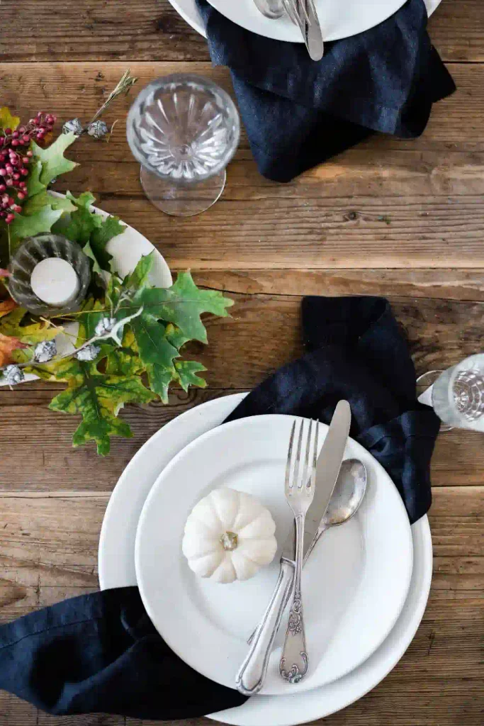 Neutral Thanksgiving table with dark-colored napkins and simple fall table decor